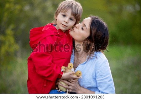 Beautiful family, mother and son, portrait for mothers day in the park, taking family portrait pictures together