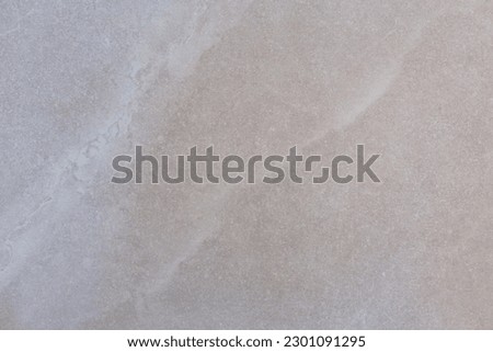 Selective focus closeup photography of pretty pale cream porcelain floor tile with wavy pattern