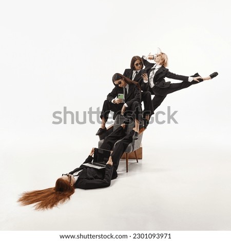 Office ballet. Portrait with group of beautiful women, ballerinas in classical suit working on white background. Concept of business, career, job, success, contemporary dance, expression, art, ad