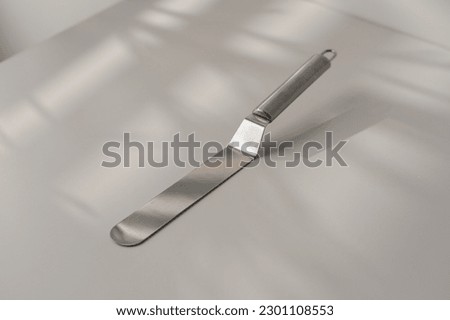 pastry spatula palette knife cooking utensils for cakes on the table on white background close-up Royalty-Free Stock Photo #2301108553