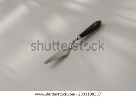 pastry spatula palette knife cooking utensils for cakes on the table on white background close-up