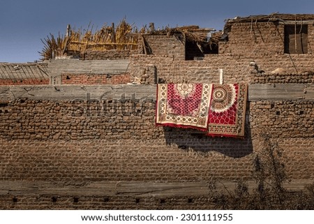 Two oriental carpets hanging over a wall in Egypt