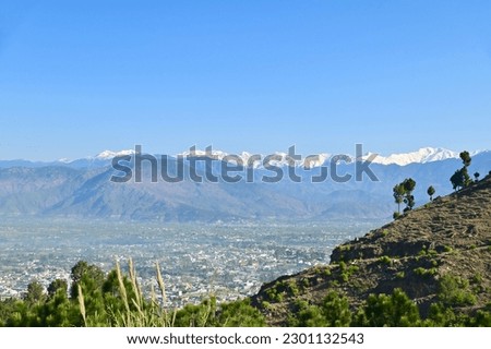 Aerial View of Mansehra City with Mountain Range in Pakistan