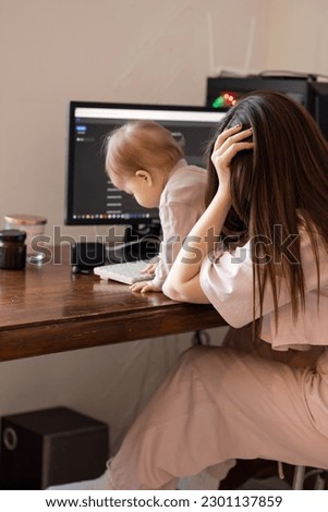 A young beautiful mother has to work, but taking care of her baby does not allow her to do it. The woman is tired and sad