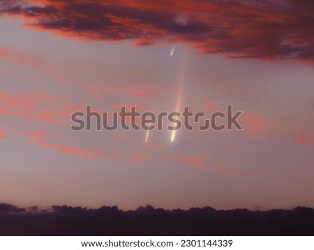 Meteors in the daytime sky. Glow of a meteorites lights up the sky at sunset. Daylight fireballs in the Earth's atmosphere.