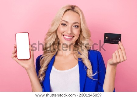 Photo of adorable shiny woman dressed blue blazer rising bank card device empty space isolated pink color background