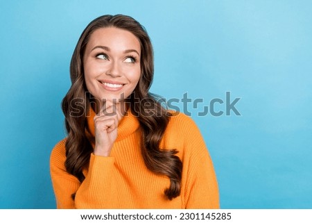 Photo of funny lady college student look empty space have brilliant idea consider wear orange jumper isolated blue color background