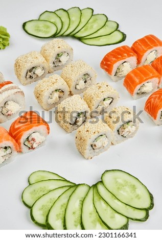 Traditional delicious fresh sushi set Philadelphia roll with salmon, smoked eel and cucumber isolated on white background. Sushi menu. Japanese asian food