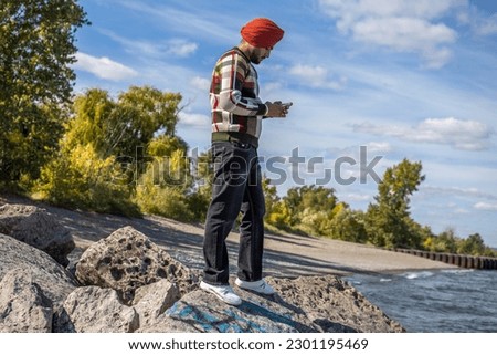 Photo of the Sikh boy standing on rocks