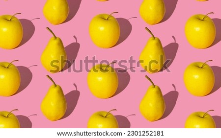 Trendy fruit pattern made of yellow pears and apples on light pastel pink background. Minimal layout. Nature summer concept.