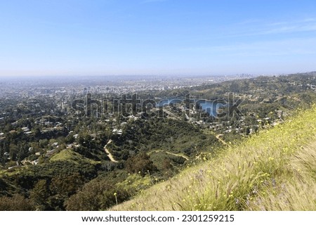 A view of Hollywood Hills and Lake Hollywood as seen from the Hollywood Sign. The buildings of Century City can be seen on the horizon.