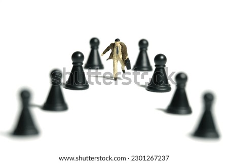 Miniature tiny people toy figure photography. A businessman running in the middle of chess pawn. Isolated on white background. Image photo