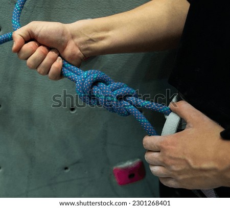 Rock Climber sets up climbing rope for indoor rock climbing,  Enhancing Climbing Performance, Essential Gear for Ascending Heights,Stylish Yet Functional,