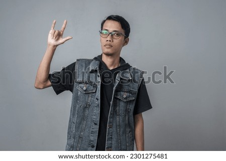 Asian men wear sleeveless blue jean jackets, metallic cuffs or the bison party (PDI Perjuangan) style. Isolated gray background.