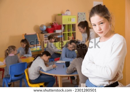 Portrait of girl and children drawing in classroom