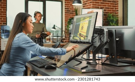 Employee game developer working in creative production department to create professional web content in office. Asian woman developing 3D graphics components with engineering software