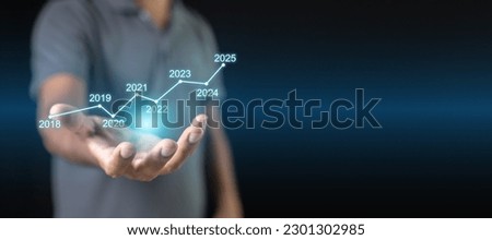 Target growth to year 2025 concept. Graph growth strategy year 2018 to 2025 on a hand businessman. Chart plan management economic finance marketing goal future. Royalty-Free Stock Photo #2301302985