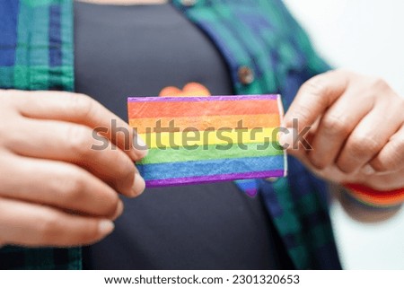 Asian woman with rainbow flag, LGBT symbol rights and gender equality, LGBT Pride Month in June.