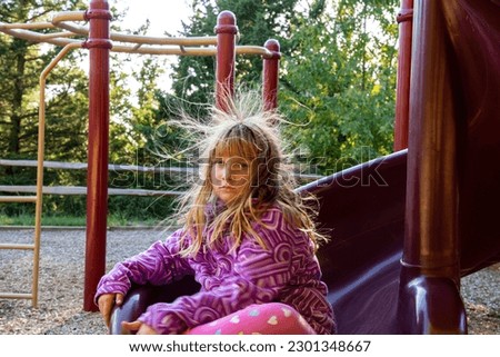 Static Electric Hair on slide Royalty-Free Stock Photo #2301348667