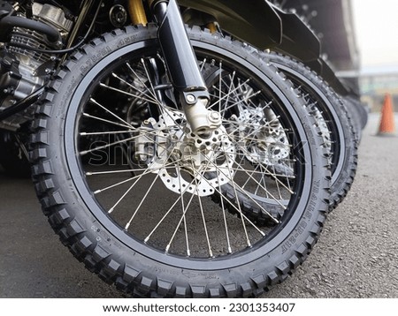 Trail bike tires are characterized by rough tire contours, re husembling checkered hoes jagged