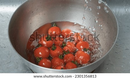 Wash cherry tomatoes with water.