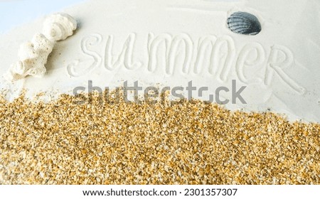 Summer vacation season, on the sea sand the inscription summer near seashells and corals.  Flat lay top view.  The concept of sea travel, vacation, vacation time.