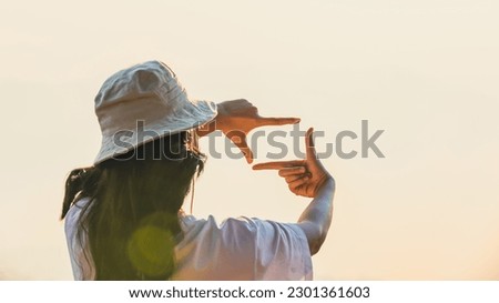 Woman Hands framing view distant over sunrise. Woman making frame round the view with her hands in sunset, Future planning idea concept. business concept. New year planning and vision concept