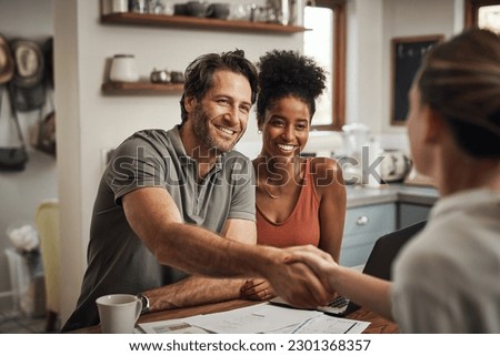 Love, handshake and couple with a financial advisor, consultation and discussion for investments. Partners, man and woman with a consultant, home and conversation for advice, help and shaking hands Royalty-Free Stock Photo #2301368357