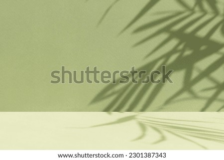 Minimal abstract background for the presentation of a cosmetic product. Empty premium podium with a shadow of tropical palm leaves on a green background. Showcase, display case. Royalty-Free Stock Photo #2301387343
