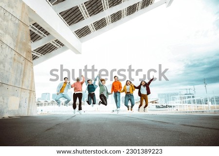 Happy group of young people jumping on city street - Multiracial students college celebrating outside - Life style concept with guys and girls having fun together hanging outside Royalty-Free Stock Photo #2301389223