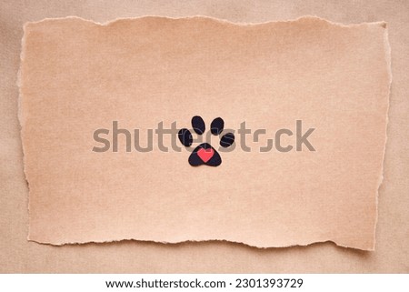 Postcard with paw print icon and heart, paper art style. Animal love concept, greeting card, invitation mockup. Flat lay, top view, copy space
