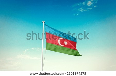 Waving flag of Azerbaijan in beautiful sky. Azerbaijan flag for independence day. Royalty-Free Stock Photo #2301394575