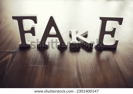The letters spelled the word fake. The concept of modern information technology. Fake and facts in news.