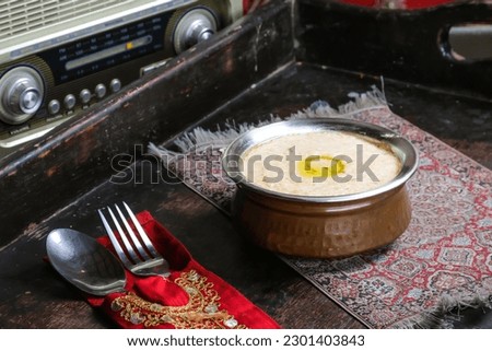 Hareesa or harees arab dish served in dish isolated on red mat top view on table arabic food Royalty-Free Stock Photo #2301403843