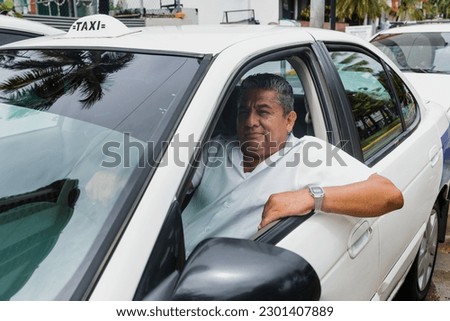portrait of latin taxi driver senior man with car on background at city street in Mexico in Latin America, Hispanic adult people Royalty-Free Stock Photo #2301407889