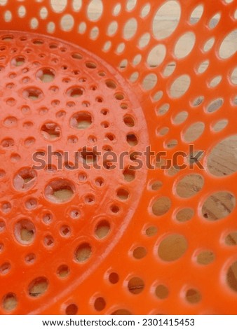 a orange plate with circle hole at the surface