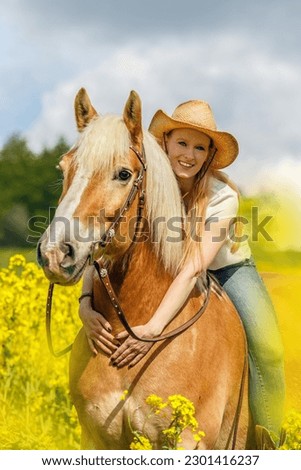 A young woman enjoying time with her haflinger horse in spring outdoors. Female equestrian friendship scene with her horse