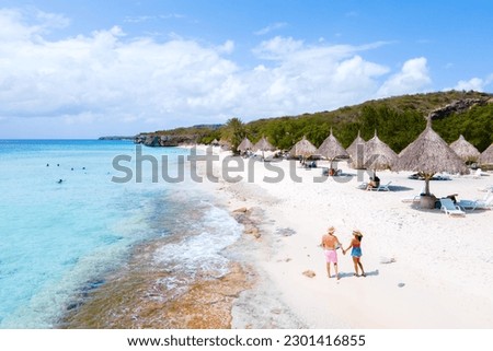 A couple of men and women walking at the beach of Cas Abao Beach Playa Cas Abao Caribbean island of Curacao, Drone aerial view Royalty-Free Stock Photo #2301416855