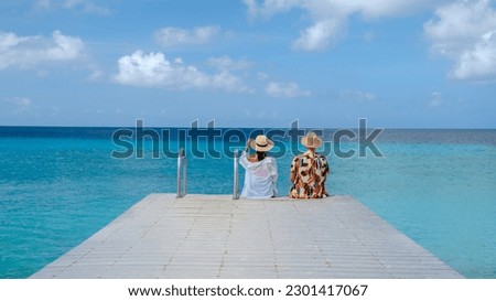 Playa Porto Marie Beach in Curacao, a Couple of men and woman on a tropical beach on the Caribbean Island of Curacao.  Royalty-Free Stock Photo #2301417067