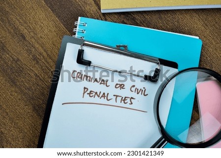 Concept of Criminal or Civil Penalties write on paperwork isolated on Wooden Table.