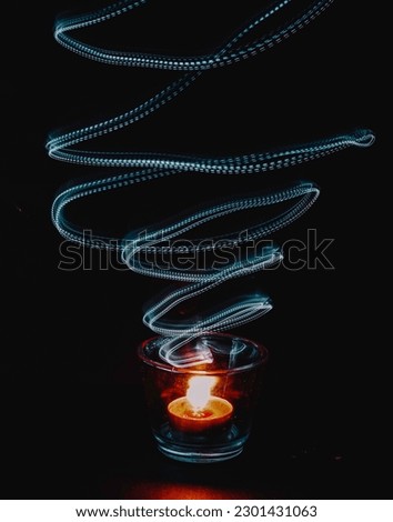 the art of smoke from the traditional torch known as pelita with slow shutter light movement. Selective focus