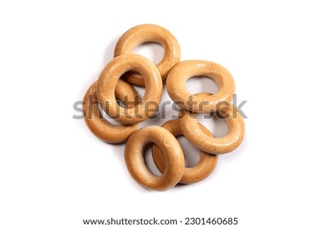 Dry bagels isolated on white, flat lay
