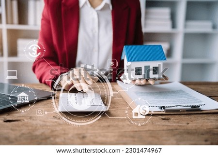 Buying a home or insurance deal, an insurance agent pointing a pen to those interested in renting a house, a contract, signing an Home buying agreement in office