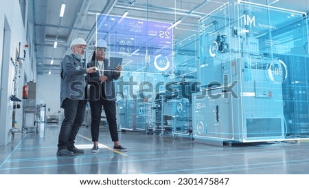 Factory Digitalization: Two Industrial Engineers Use Tablet Computer, Big Data Statistics Visualization, Optimization of High-Tech Electronics Facility. Industry 4.0 Machinery Manufacturing Products