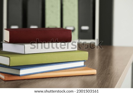Many different books stacked on wooden table indoors, space for text