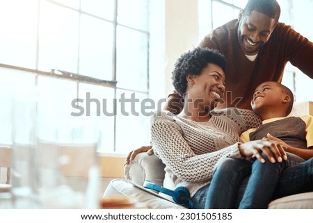 Happy, love and family bonding on a sofa together in the living room of their modern house. Happiness, smile and African parents spending quality time, talking and relaxing with her boy child at home Royalty-Free Stock Photo #2301505185