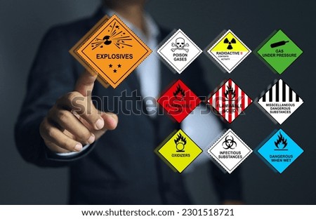 Supervisor or leader pointing to the explosives symbols and all type of the various types of dangerous goods involved. Royalty-Free Stock Photo #2301518721