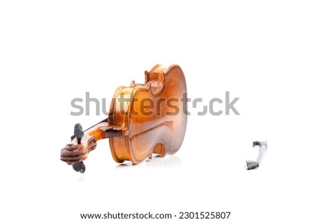 small model of an old used violin with bow isolated on white with real shadows