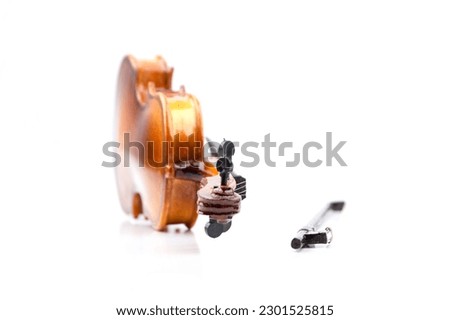 small model of an old used violin with bow isolated on white with real shadows
