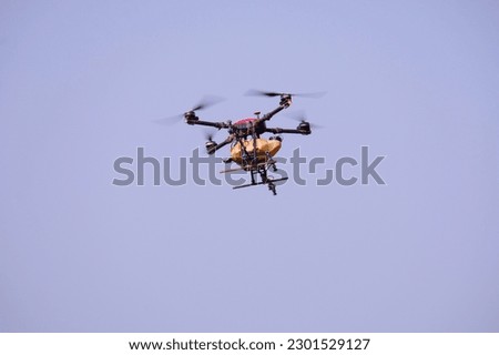 agricultural drone Spraying fertilizers or agricultural chemicals flying in the sky.
